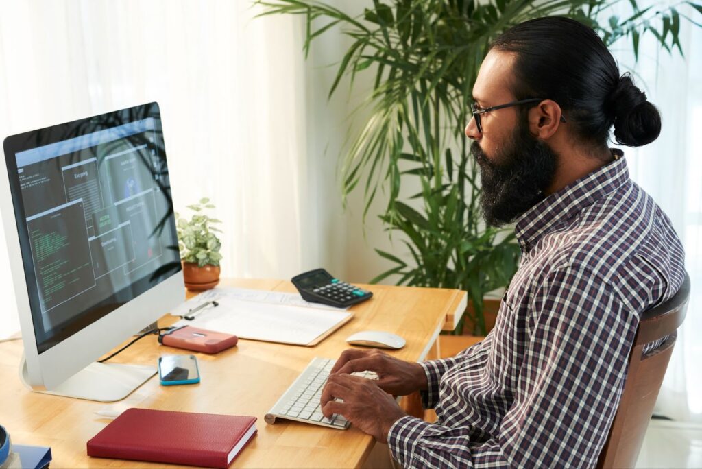 IT engineer working with code on his PC