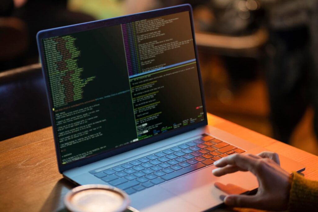 Man in front of computer working with codes