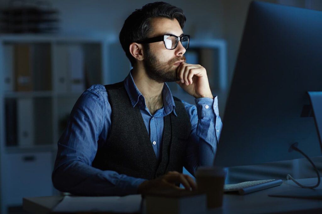 A man works at night at the computer