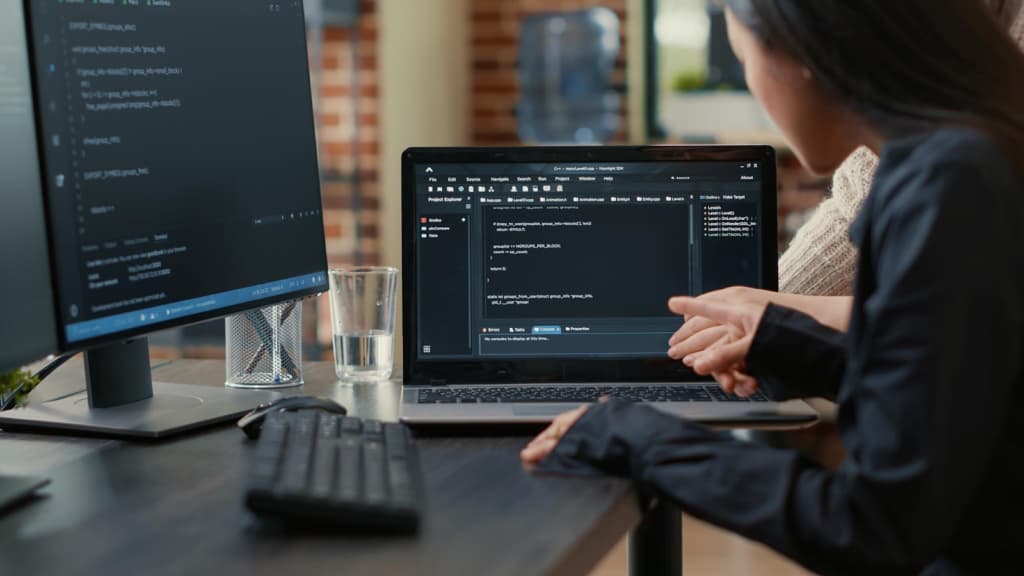 A team of programmers talks about an algorithm running on a laptop screen