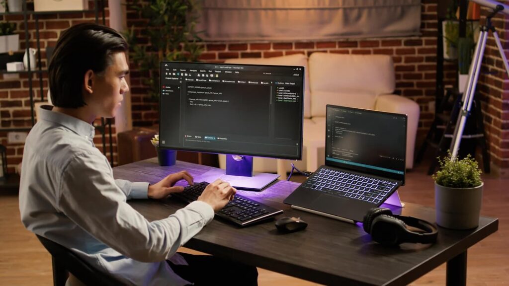 Man working at computer with codes
